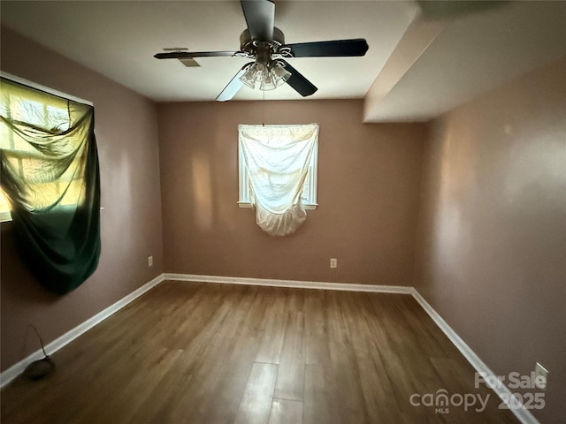 spare room with hardwood / wood-style flooring and ceiling fan