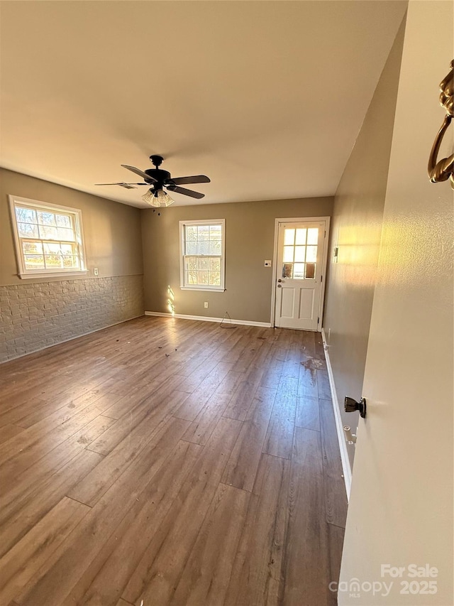 interior space with ceiling fan and wood-type flooring