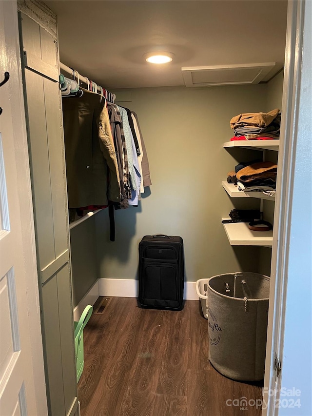 spacious closet featuring dark hardwood / wood-style flooring