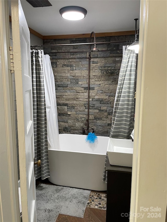 bathroom with vanity and shower / bath combo