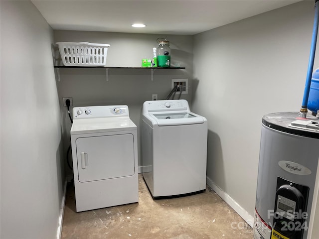 clothes washing area featuring separate washer and dryer and gas water heater