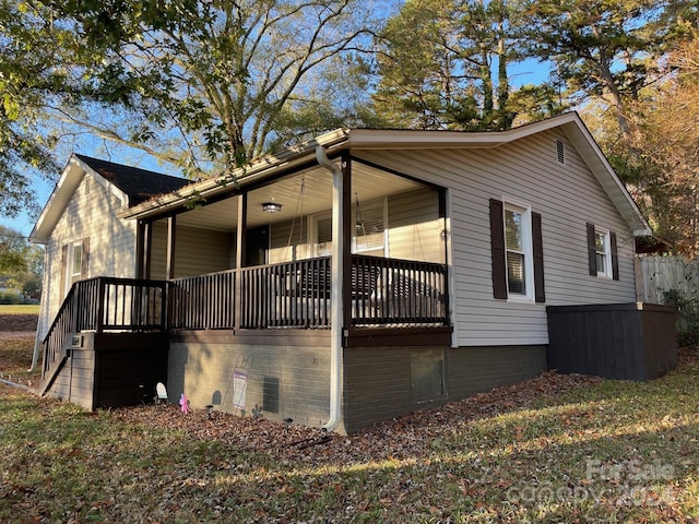 view of side of home with a porch