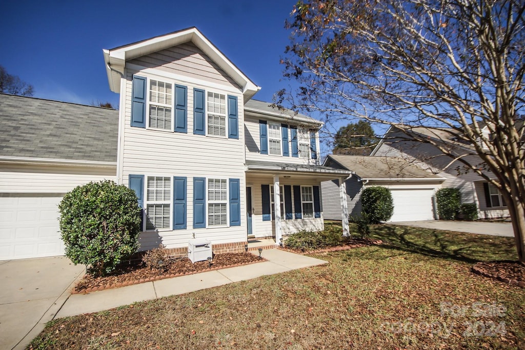 view of front of home featuring a garage and a front lawn