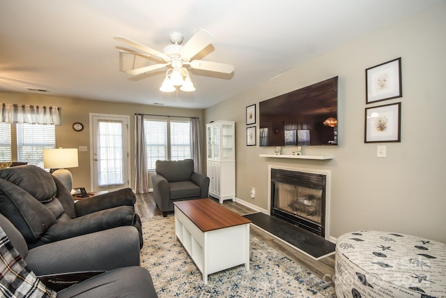 living room with ceiling fan and light hardwood / wood-style flooring