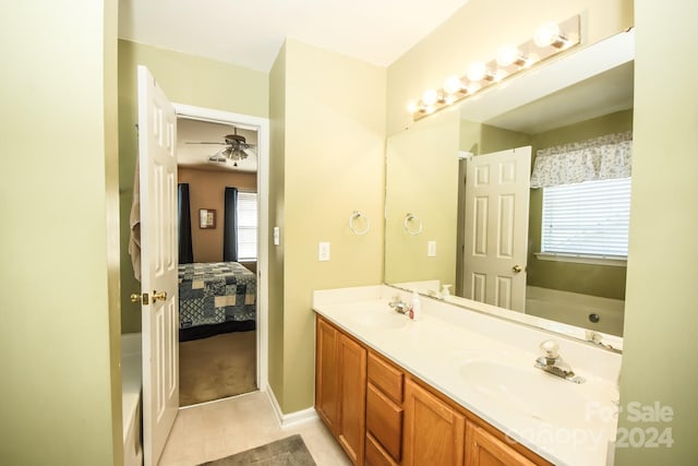 bathroom featuring tile patterned floors, ceiling fan, vanity, and a healthy amount of sunlight