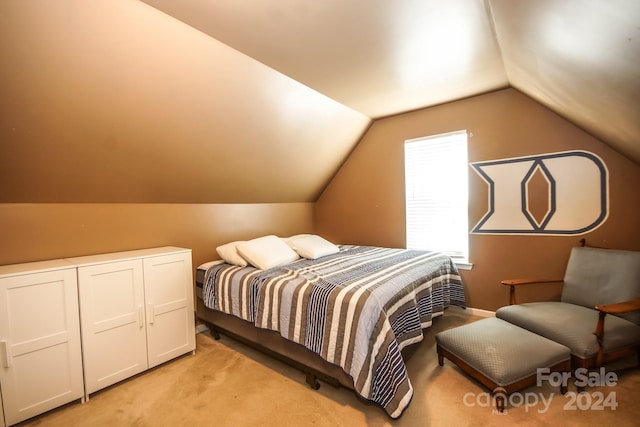 bedroom with light colored carpet and vaulted ceiling