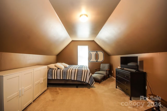 bedroom with light carpet and lofted ceiling