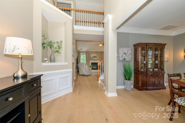 9618 Belloak Ln, Waxhaw, NC 28173 - foyer with light wood finished floors, stairway, crown molding, and ceiling fan