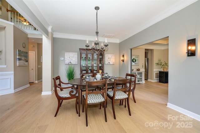 9618 Belloak Ln, Waxhaw, NC 28173 - dining room with light wood finished floors, crown molding, a chandelier, and baseboards