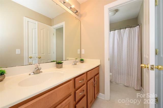 9618 Belloak Ln, Waxhaw, NC 28173 - full bathroom with toilet, double vanity, baseboards, a shower with curtain, and tile patterned floors