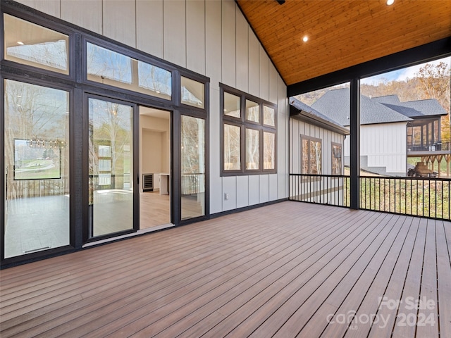 unfurnished sunroom with wooden ceiling, lofted ceiling, and plenty of natural light