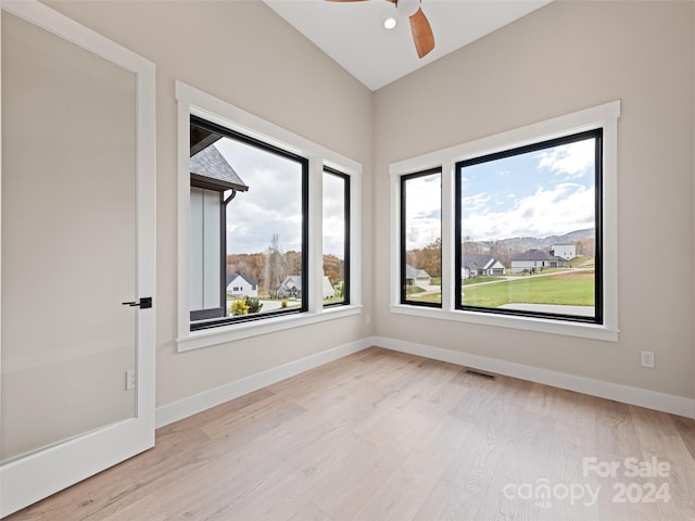 spare room featuring ceiling fan, plenty of natural light, and light hardwood / wood-style flooring