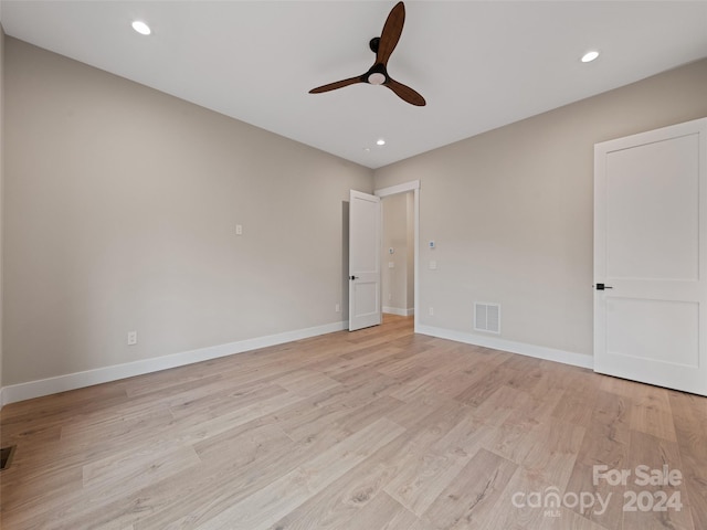 unfurnished bedroom with ceiling fan and light hardwood / wood-style floors