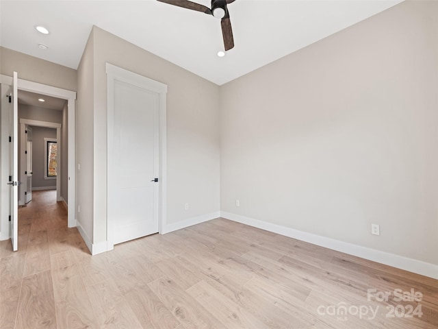 unfurnished bedroom featuring ceiling fan and light hardwood / wood-style flooring