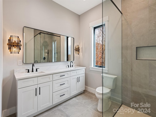 bathroom featuring vanity, toilet, and tiled shower