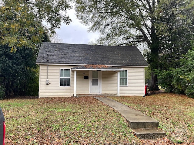 bungalow-style home with a front lawn