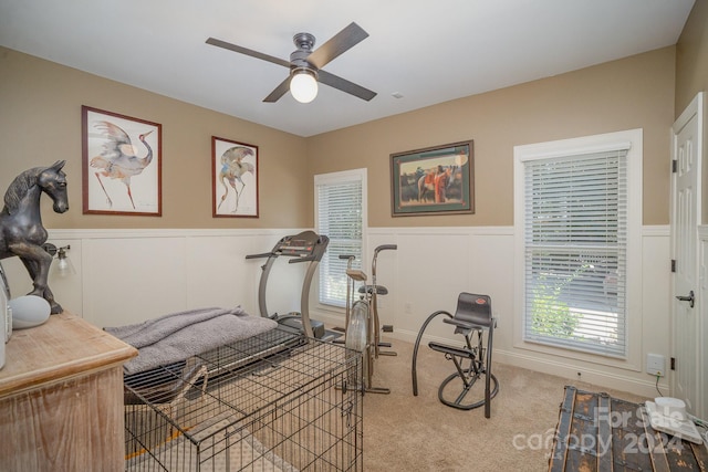 bedroom with light carpet, multiple windows, and ceiling fan