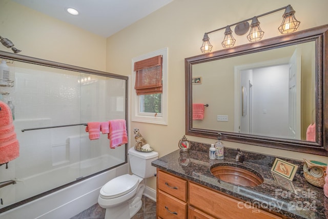 full bathroom with shower / bath combination with glass door, vanity, toilet, and tile patterned flooring