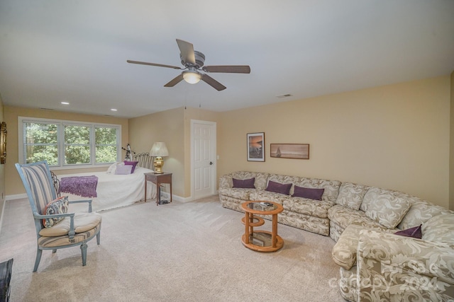 living room featuring ceiling fan and light colored carpet