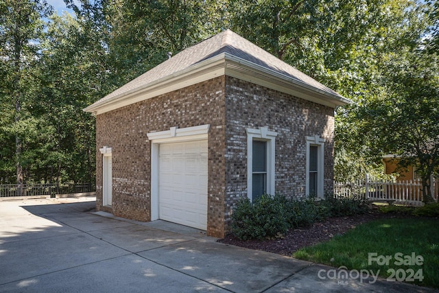 view of side of home with a garage and an outdoor structure