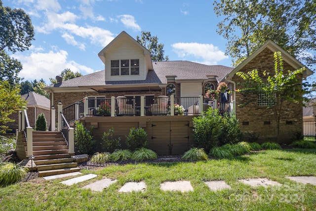 rear view of property with a lawn