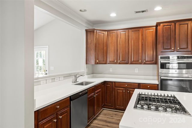 kitchen with sink, ornamental molding, stainless steel appliances, and dark wood-type flooring