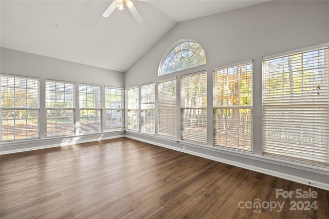 unfurnished sunroom featuring vaulted ceiling, ceiling fan, and a healthy amount of sunlight