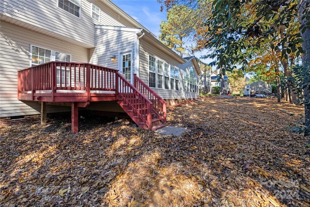 view of property exterior with a wooden deck