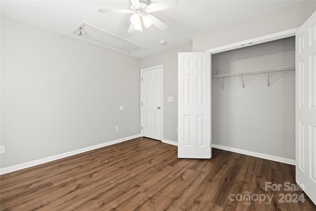 unfurnished bedroom with ceiling fan, dark hardwood / wood-style flooring, and a closet