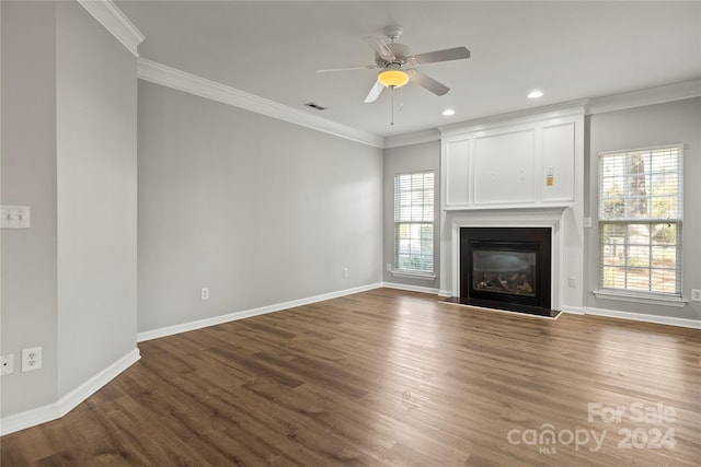 unfurnished living room featuring crown molding, ceiling fan, and dark wood-type flooring