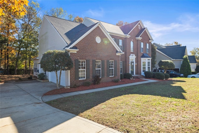 view of property with a garage and a front yard