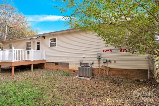 back of property featuring central AC unit and a deck