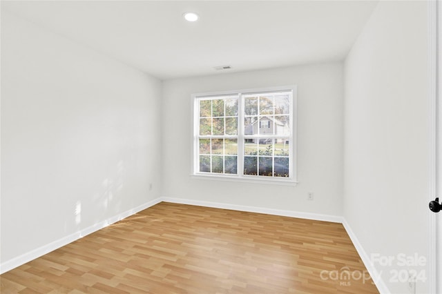 spare room with light hardwood / wood-style floors