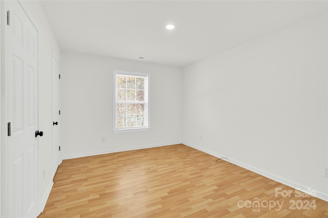 unfurnished bedroom with light wood-type flooring