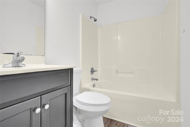 full bathroom with vanity, hardwood / wood-style flooring, toilet, and tub / shower combination