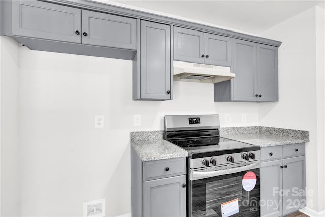 kitchen with gray cabinets and stainless steel stove