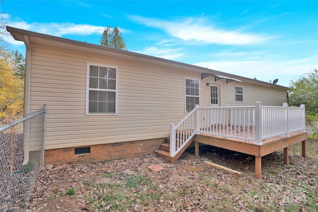 back of property with a wooden deck