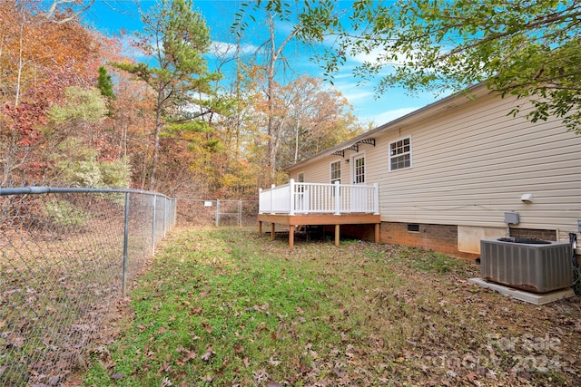 view of yard featuring a wooden deck and cooling unit