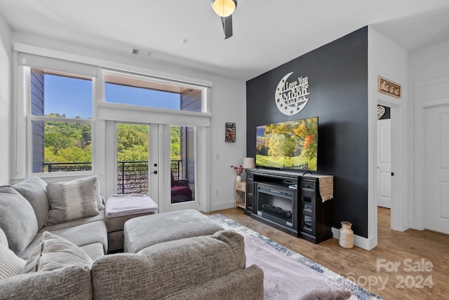 living room with ceiling fan and light hardwood / wood-style floors