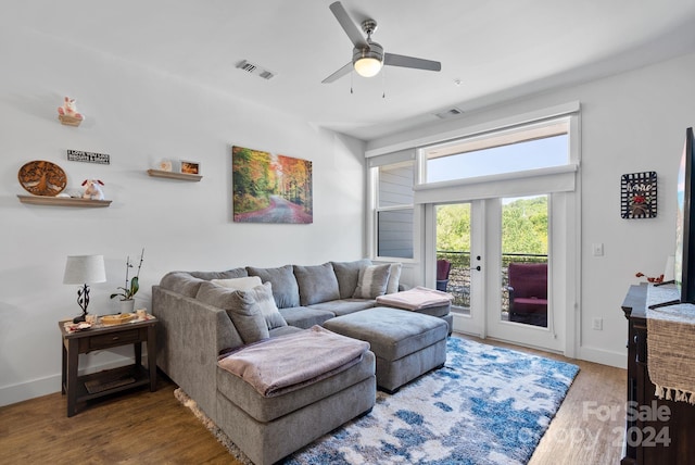 living room featuring ceiling fan and wood-type flooring