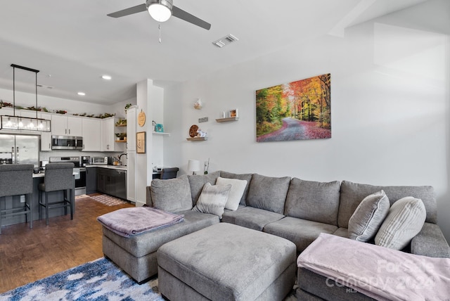 living room featuring dark hardwood / wood-style flooring and ceiling fan