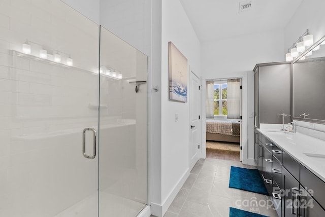 bathroom with tile patterned flooring, vanity, and an enclosed shower