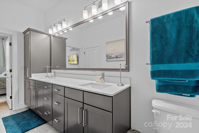 bathroom with tile patterned floors, vanity, and toilet