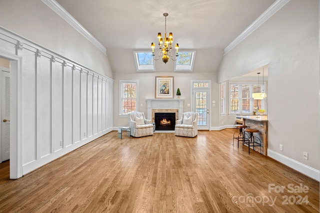 sitting room featuring wood-type flooring, plenty of natural light, and ornamental molding