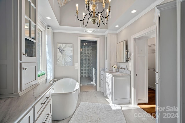 bathroom featuring a notable chandelier, shower with separate bathtub, hardwood / wood-style flooring, vanity, and ornamental molding