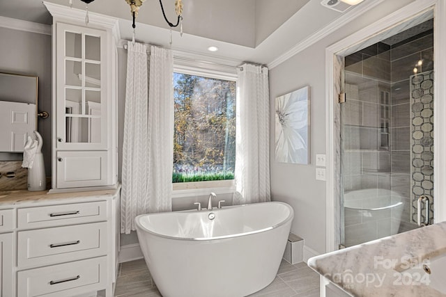 bathroom with a chandelier, vanity, separate shower and tub, and ornamental molding