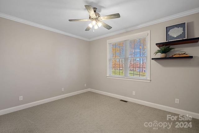 spare room with carpet, ceiling fan, and ornamental molding