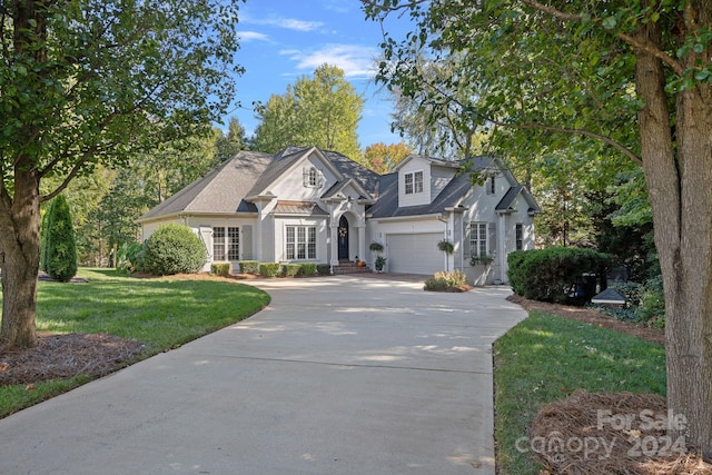 view of front of property with a garage and a front yard