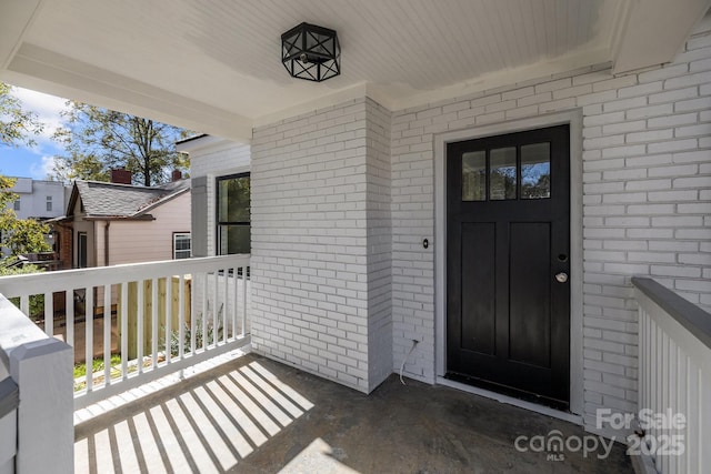 view of exterior entry with a porch