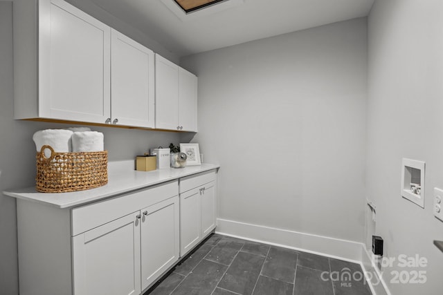 washroom with cabinets and hookup for a washing machine